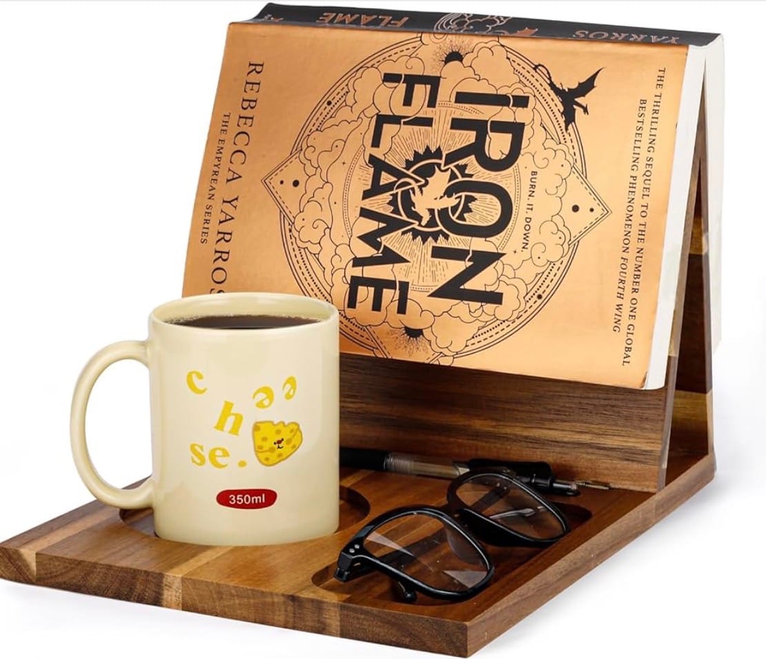 Wooden book stand with book, glasses and cup of coffee